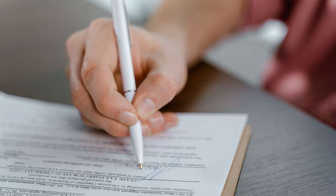 Pessoa assinando escritura pública de doação com reserva de usufruto em cartório