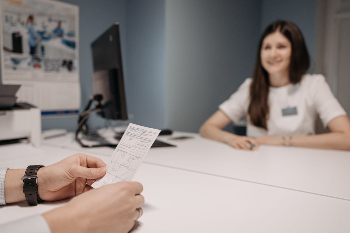Médica analisa prescrição médica durante consulta